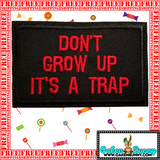 3.05"x2" DON'T GROW UP IT'S A TRAP Red Stitching on Black Twill Embroidered Patch with Choice of Backing